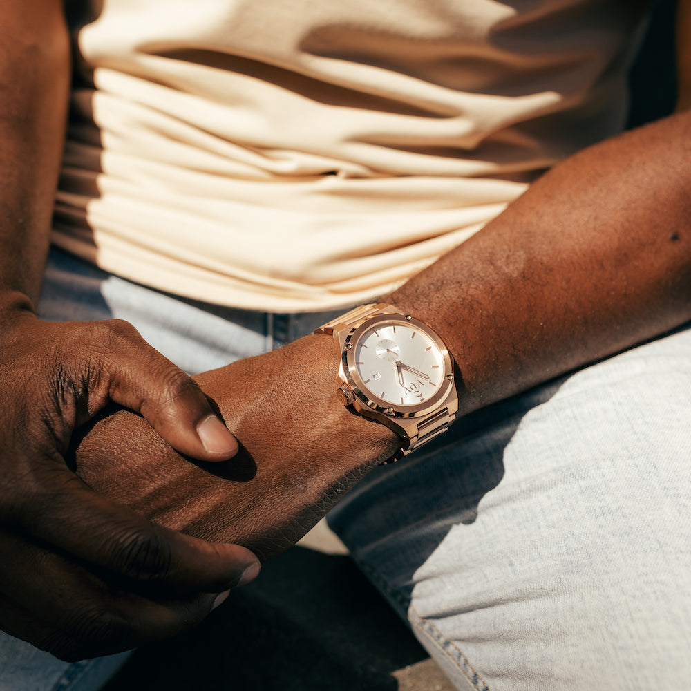 Rose Gold Kairos on wrist of man sitting down